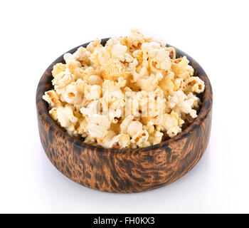 Popcorn in the wooden bowl isolated on a white background