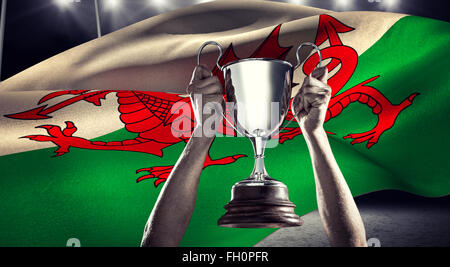 Composite image of successful rugby player holding trophy Stock Photo