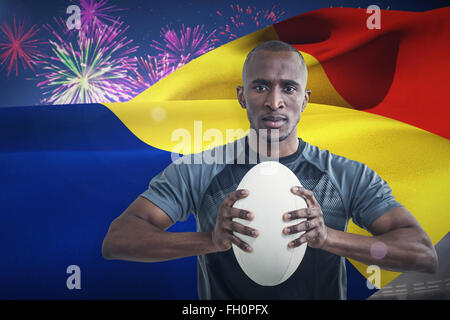 Composite image of portrait of athlete pressing rugby ball Stock Photo