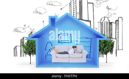 Composite image of business woman lying on couch Stock Photo