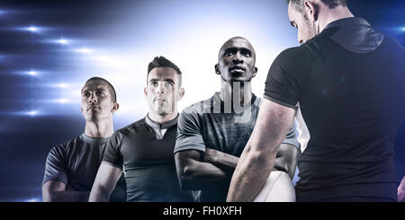 Composite image of tough rugby player holding ball Stock Photo