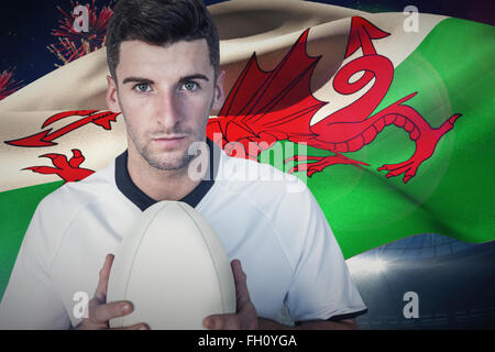 Composite image of portrait of a player holding rugby ball Stock Photo