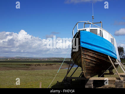 Fishing boat under repair on the Loughor Estuary, Penclawdd, north Gower, Swansea, South Wales, UK Stock Photo