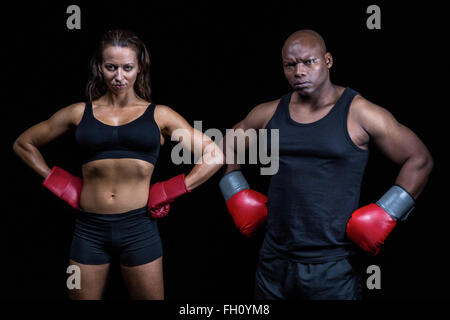 Portrait of male and female boxers with hands on hip Stock Photo