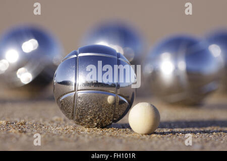 A boules set with Cochonnet or jack on sandy beach. Stock Photo