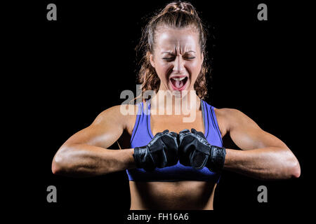 Aggressive female boxer flexing muscles Stock Photo