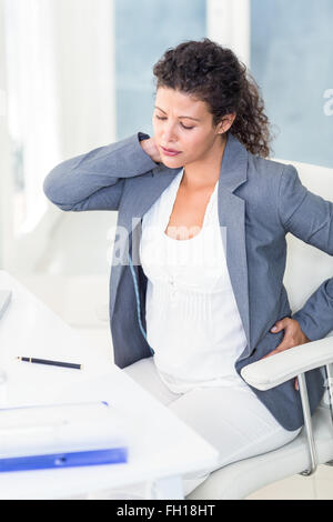 Tired pregnant businesswoman Stock Photo