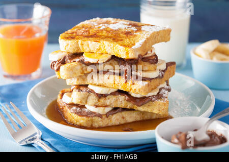 french toasts with banana chocolate sauce and caramel for breakfast Stock Photo