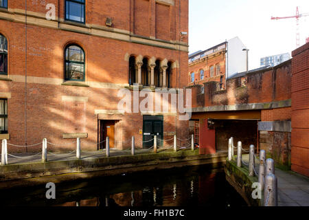 Manchester, UK - 15 February 2016: The narrow entrance through the Great Bridgewater Street to the Barbirolli Square Canal Basin
