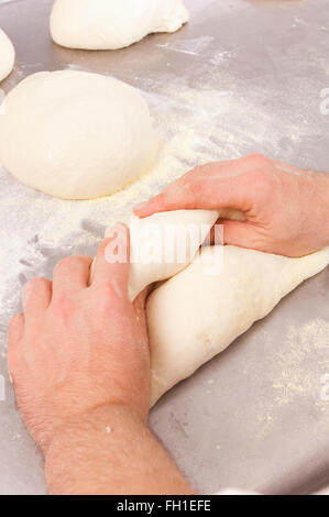 Baker prepares the dough bread and pizza Stock Photo