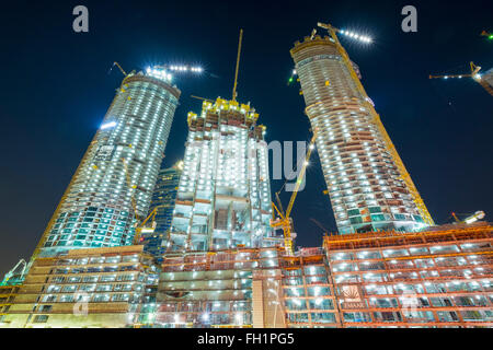 Night view of construction site of new high-rise luxury apartment towers in Dubai United Arab Emirates Stock Photo