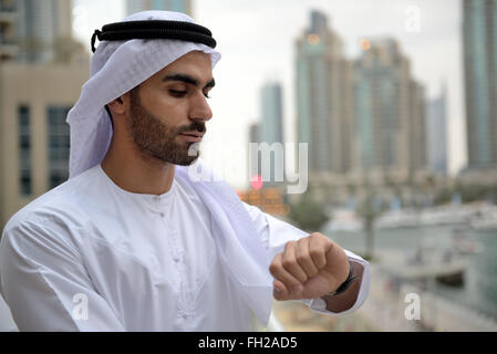Young Emirati arab businessman standing by the canal Stock Photo