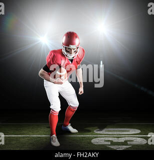 Composite image of portrait of focused american football player being ready to attack