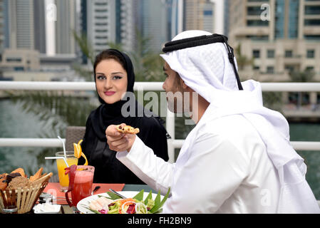 Young Emirati arab couple dining at a restaurant Stock Photo
