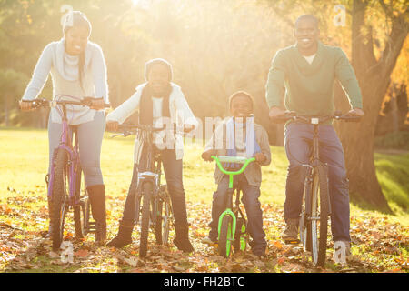 Young smiling family doing a bike ride Stock Photo
