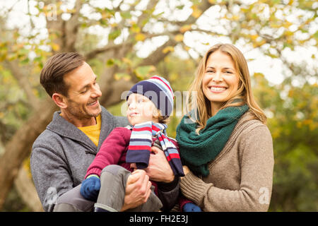 Smiling young couple with little boy posing Stock Photo
