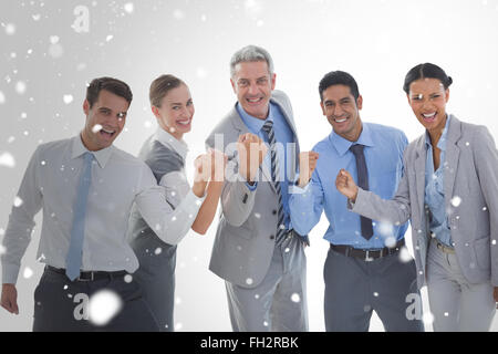 Composite image of portrait of successful business people clenching fists Stock Photo