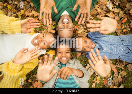 Young family doing a head circles and raising their hands Stock Photo
