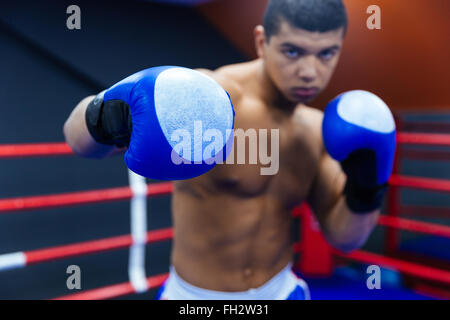 Male boxer fighting in boxing ring Stock Photo