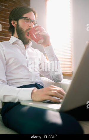 Businessman using laptop on the couch Stock Photo