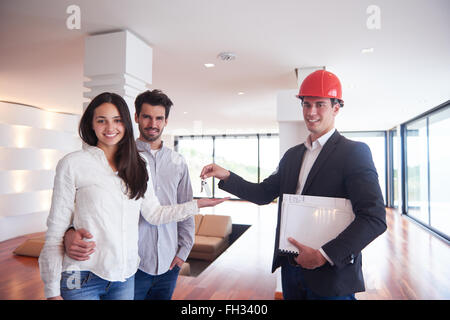 couple buying new home with real estate agent Stock Photo