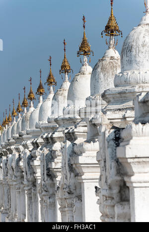 Row of whitewashed stupas at Kuthodaw Pagoda in Mandalay, Burma (Myanmar) Stock Photo