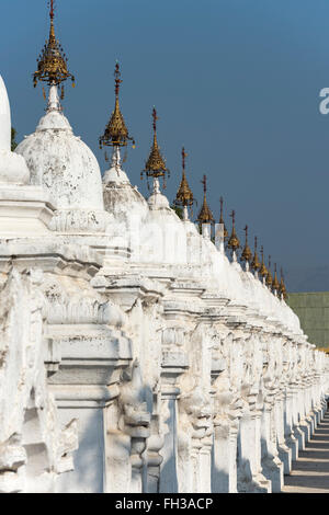 Row of white  kyauksa gu stupas at Kuthodaw Pagoda in Mandalay, Burma (Myanmar) Stock Photo