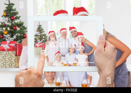 Composite image of hand holding tablet pc Stock Photo
