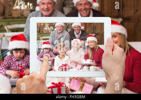Composite image of hand holding tablet pc Stock Photo