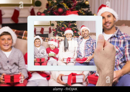 Composite image of hand holding tablet pc Stock Photo