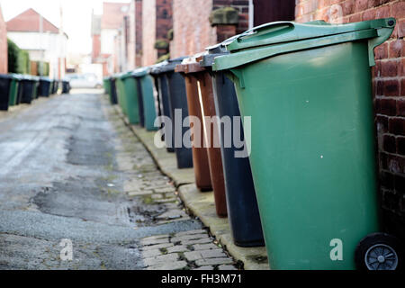 Wheelie bins line both sides of a backstreet in Leeds, West Yorkshire Stock Photo