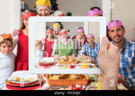 Composite image of hand holding tablet pc Stock Photo