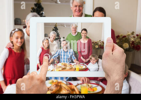 Composite image of hand holding tablet pc Stock Photo
