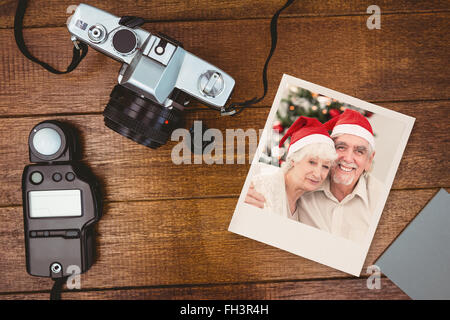 Composite image of happy couple on the couch at christmas Stock Photo
