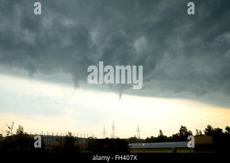 Dark clouds gathering before storm. Clear border between good and bad weather. Stock Photo