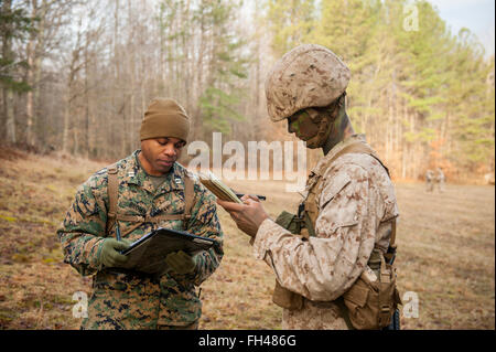 Candidates assigned to Delta Company, Officer Candidates Class-221, are evaluated as members of a fire team during the Small Unit Leadership Evaluation 1 at Brown Field, Marine Corps Base Quantico, Va., on Feb. 22, 2016. The mission of Officer Candidates School (OCS) is to 'educate and train officer candidates in Marine Corps knowledge and skills within a controlled, challenging, and chaotic environment in order to evaluate and screen individuals for the leadership, moral, mental, and physical qualities required for commissioning as a Marine Corps officer.' Stock Photo