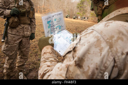 Candidates assigned to Delta Company, Officer Candidates Class-221, are evaluated as members of a fire team during the Small Unit Leadership Evaluation 1 at Brown Field, Marine Corps Base Quantico, Va., on Feb. 22, 2016. The mission of Officer Candidates School (OCS) is to 'educate and train officer candidates in Marine Corps knowledge and skills within a controlled, challenging, and chaotic environment in order to evaluate and screen individuals for the leadership, moral, mental, and physical qualities required for commissioning as a Marine Corps officer.' Stock Photo