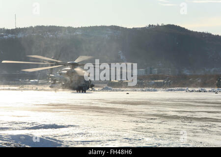 A CH-53E Super Stallion makes its way down the flight line at Vaernes, Norway, Feb. 22, 2016, as 2nd Marine Expeditionary Brigade prepares for Exercise Cold Response. All aircraft with Marine Heavy Helicopter Squadron (-) Reinforced, the Air Combat Element of 2d MEB, were dismantled at Marine Corps Air Station Cherry Point, N.C., and flown to Norway in U.S. Air Force C-5 Galaxies to provide air support during the exercise. Cold Response 16 is a combined, joint exercise comprised of 12 NATO allies and partnered nations and approximately 16,000 troops. Stock Photo