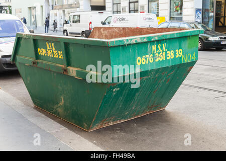 Vienna, Austria - November 2, 2015: Big green trash container stands on a roadside in the city Stock Photo