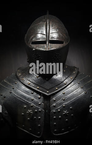 Ancient metal armor of the medieval knight. Dark vertical photo Stock Photo