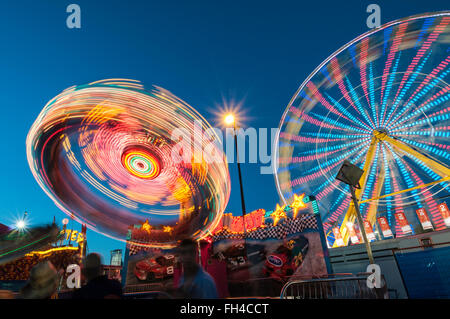 Ferris wheel and midway rides at night, Calgary Stampede Midway, Calgary, Alberta, Canada Stock Photo