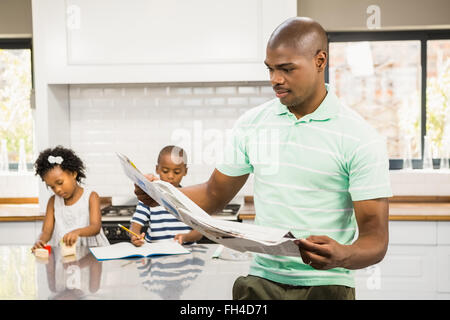 Concentrated father reading paper Stock Photo