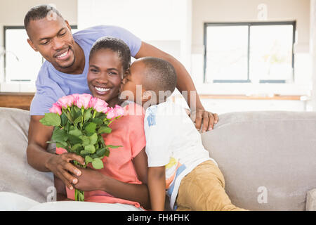 Son surprising mother with flowers Stock Photo