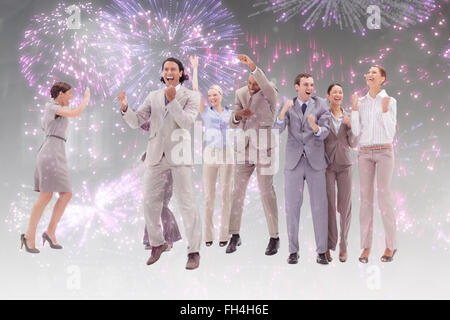 Composite image of very happy business people jumping and clenching their fists Stock Photo