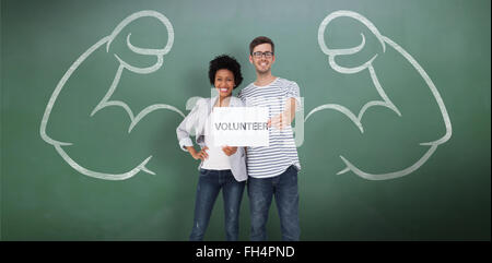 Composite image of portrait of a happy couple holding a volunteer note Stock Photo