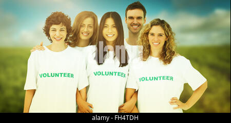 Composite image of group of people wearing volunteer tshirt Stock Photo