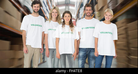Composite image of group portrait of happy volunteers Stock Photo