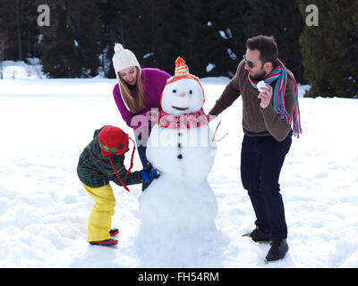 happy family making snowman Stock Photo