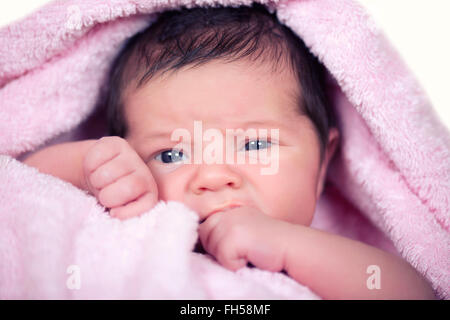 Newborn baby  girl on a soft pink terry towel Stock Photo