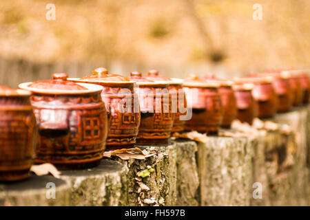 Traditional Ceramic Jugs on stumps. Stock Photo